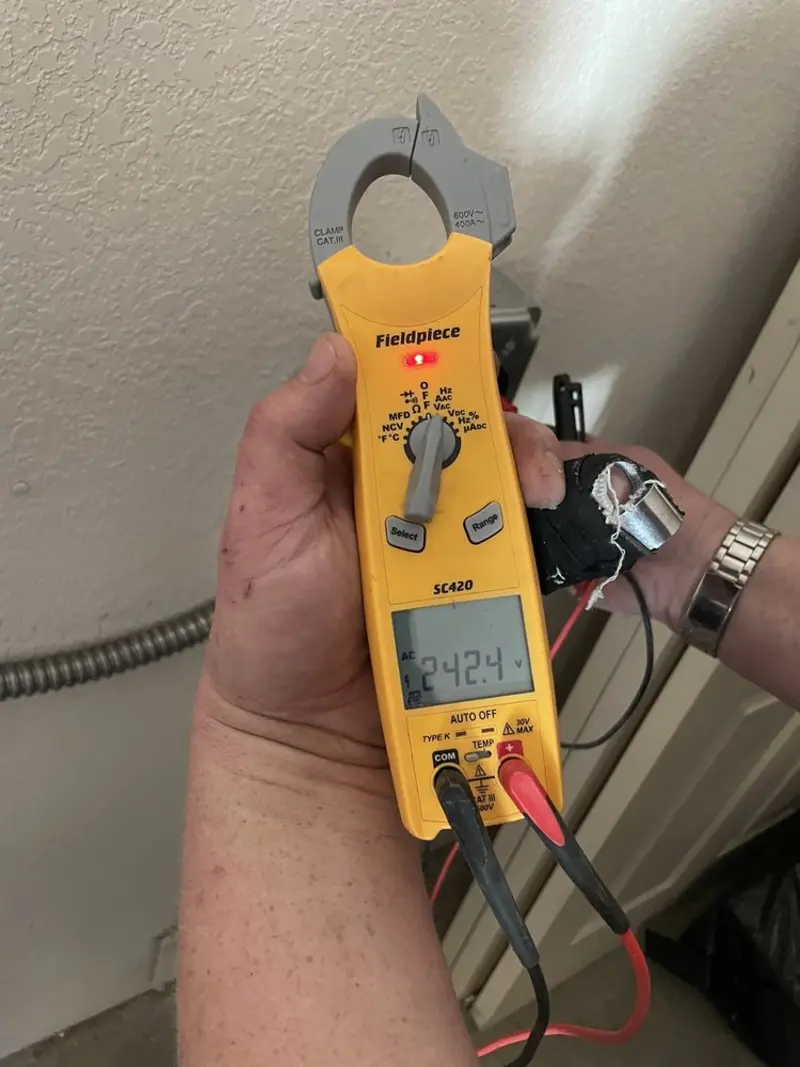 Voltage testing with clamp meter during Outlet Installation in Glenview